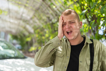 Sad caucasian man with hearing aids outdoors.