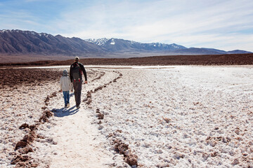 family of two, father and son, walking and hiking in lagunas escondidas, secret lagoons, in atacama...