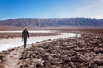 family of two, father and son, walking and hiking in lagunas escondidas, secret lagoons, in atacama desert, chile - driest place on earth, family adventure concept
