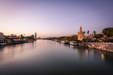 Blue Hour view Golden tower or Torre del Oro along the Guadalquivir river, Seville, Andalusia, Spain.