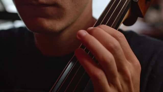 Man playing cello close up of fingers 
