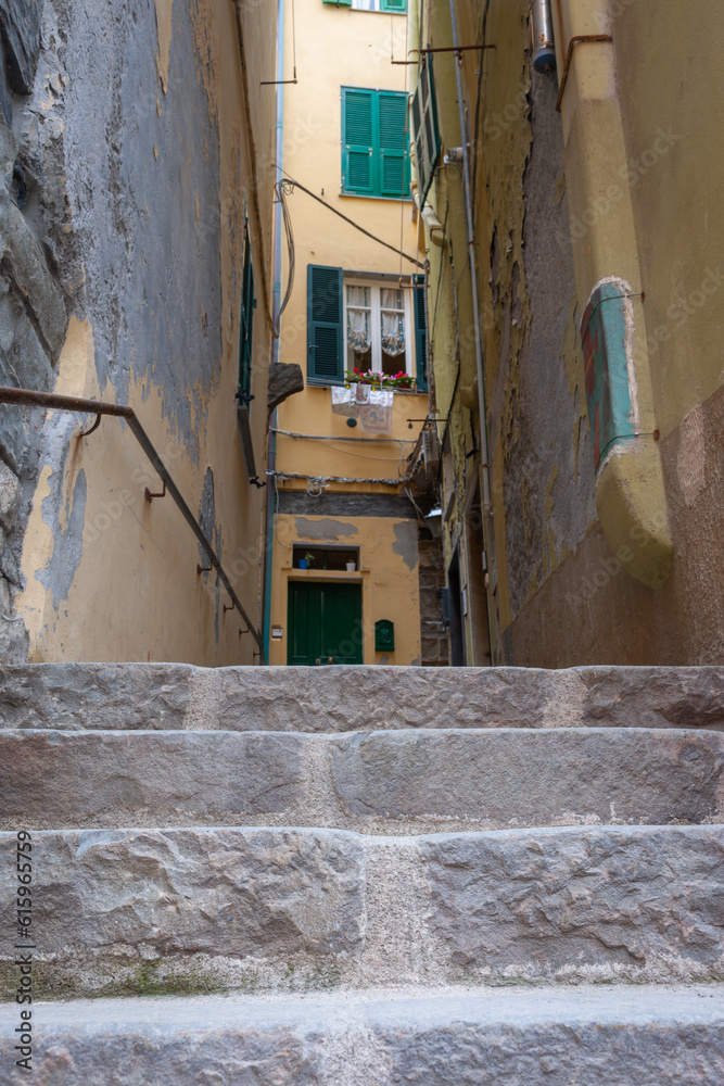 Sticker european village narrow ally with stone steps in selective focus and out of focus background buildin