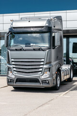 Fleet of company electric vehicle charging in the logistic hall center. Unloading of a semi truck used for delivery. sun and wind energy production facility