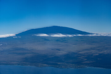 Mauna Kea,  Big island, Hawaii. Aerial photography on the plane to Kona airport. A shield volcano is a type of volcano named for its low profile, resembling a shield lying on the ground.