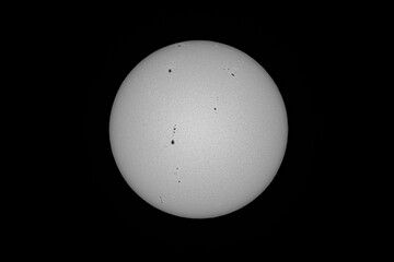 Sunspots are phenomena on the Sun's photosphere that appear as temporary spots that are darker than the surrounding areas. solar photography, astrophotography. Waikiki Honolulu Oahu Hawaii