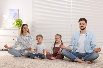 Family meditating together at home. Harmony and zen