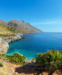 Paradise sea bay with azure water and beach view from coastline trail of Zingaro Nature Reserve Park, between San Vito lo Capo and Scopello, Trapani province, Sicily, Italy. Two shots stitch image.