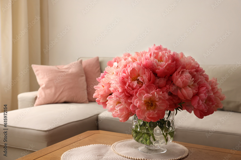 Wall mural Beautiful pink peonies in vase on table at home, space for text. Interior design