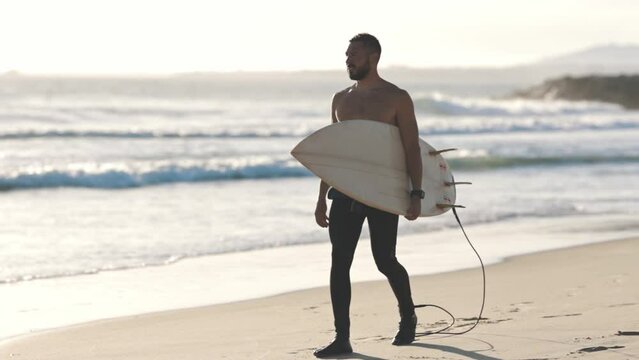 Naked torso surfer walk along coast with surfboard