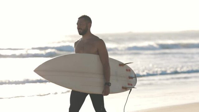 Surfer walk along coast with surfboard