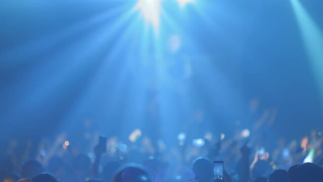 A lot of people with flashlights at a live concert