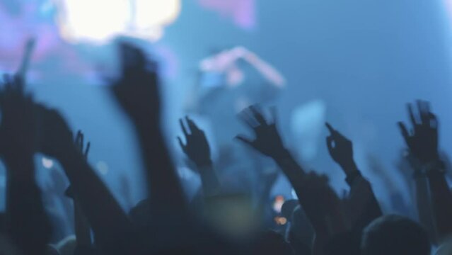 Audience of concert waving arms from side to side