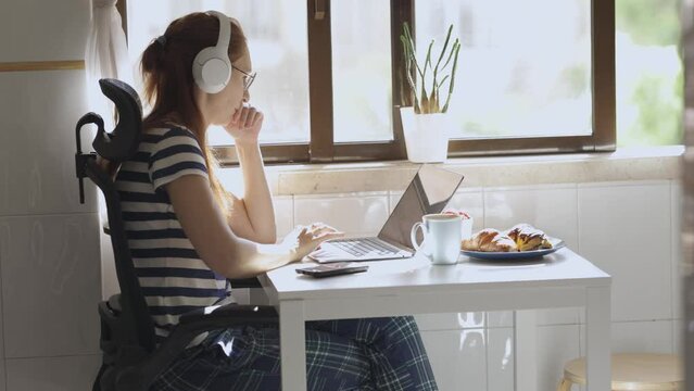 Designer put on headphones - start working on lapt