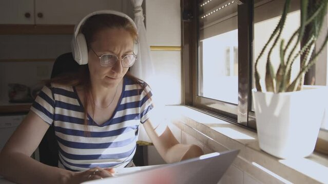 Home office, woman doing work at home using laptop