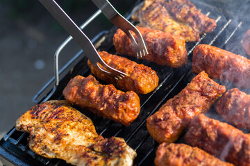 Close up of traditional Romanian food made of pork/beaf meat called mici or mititei fried on mangal barbeque grill