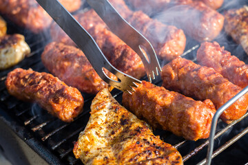 Close up of traditional Romanian food made of pork/beaf meat called mici or mititei fried on mangal...