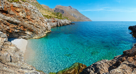 Paradise sea bay with azure water and beach. View from coastline trail of Zingaro Nature Reserve Park, between San Vito lo Capo and Scopello, Trapani province, Sicily, Italy. Two shots stitch panorama - obrazy, fototapety, plakaty
