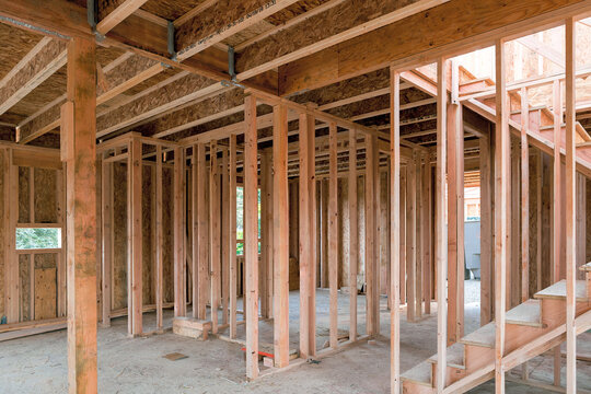 New home construction interior wood stud framing ceiling beams and stair