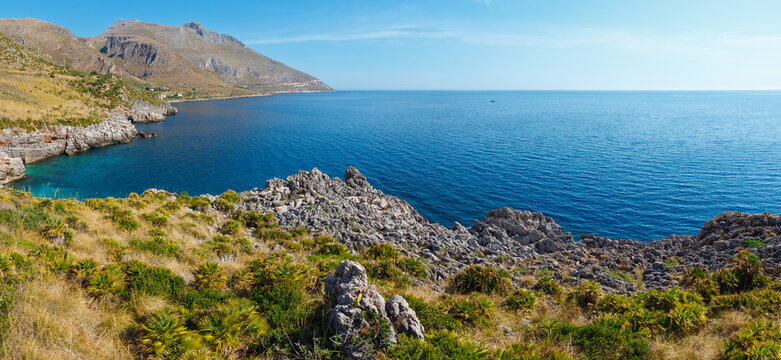 Paradise sea bay with azure water, view from coastline trail Zingaro Nature Reserve Park, between San Vito lo Capo and Scopello, Trapani province, Sicily, Italy. Two shots stitch panorama.