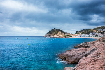 Fototapeta na wymiar Stormy weather on Spanish mediterranean coast at the Costa Brava with village Tossa de Mar and his medieval castle