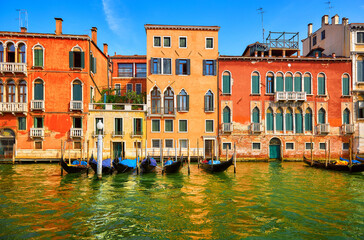 Venice, Italy. Gondolas with floating at piers by Grand Canal among antique buildings and...