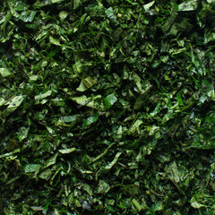 Obraz premium Top view of sliced pumpkin leaves, nigerian ugw leaves sliced for cooking, sliced fluted pumpkin leaves