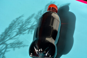 a black drink with a red cap and a transparent bottle.