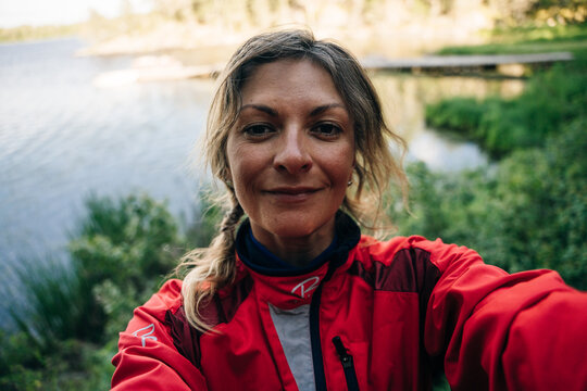 Happy cyclist taking selfie in front of nature
