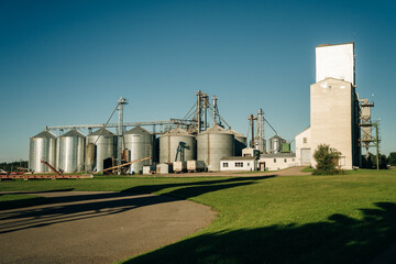 Modern Granary elevator. Silver silos on agro-processing and manufacturing plant for processing...