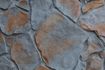 Gray and orange flagstone wall texture background