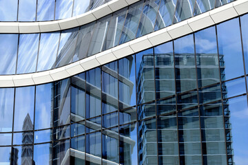 glass curtain wall closeup with strong reflections. modern building. shiny reflective facade....