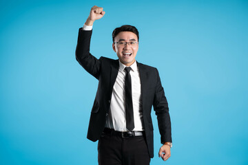  image of young businessman posing on blue background