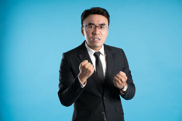  image of young businessman posing on blue background