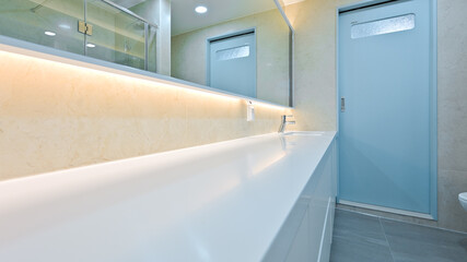 Fototapeta na wymiar A bathroom with a long horizontal washbasin to make it feel like a hotel