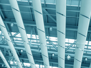 Lights and ventilation system in long line on ceiling of the  industrial building. Exhibition Hall. Blue ceiling factory construction