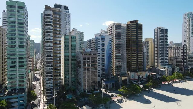 Aerial view of the beach and coming closer to tall buildings in Balneario Camboriu Brazil