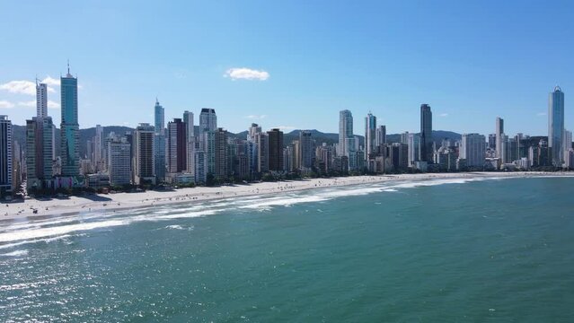 Drone shot of Balneario Camboriu Brazil, from the sea, of the beach and buildings on the background
