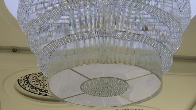 Interior glass lights inside the At-Thohir Mosque, a magnificent white mosque located in the Podomoro Golf View area, Tapos, Depok, West Java, Indonesia
