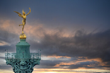 6 May 2023 Paris, France. Close up detail of gilded winged Mercury atop the Bastille Column in...