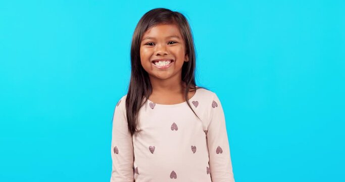 Smile, emoji and face of girl in studio with happiness, excited and young children on blue background mockup. Portrait, happy and positive expression for chroma key announcement, promotion or sale