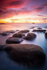 Fototapeta na wymiar rock on the sea with a sunset color.