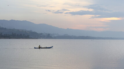 A man rowing a boat on the lake.