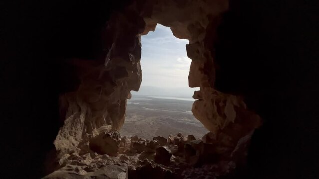Footage at an archaeological site in the desert, going in and out of an ancient window to view a wide desert landscape. View of the Judean Desert and Dead Sea from Masada Fortress in southern Israel.