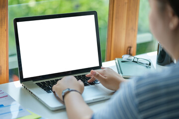 Over shoulder view of male freelancer working online, typing email on laptop computer..