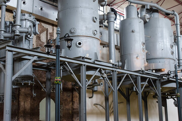 Fototapeta na wymiar Steam engine tanks in a sugar factory