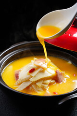 Thick soup made from bamboo shoots, pork slices, goji berries and various spices, Hunan cuisine, Chinese food, indoor shot, dark background