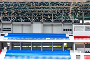 Rows of tribun for fans at empty large football stadium