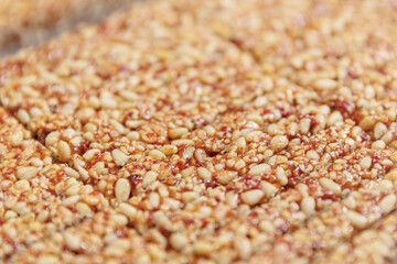 Closeup Kozinak healthy cake, Snacks from peanuts, pine nuts. Concept modern food industry