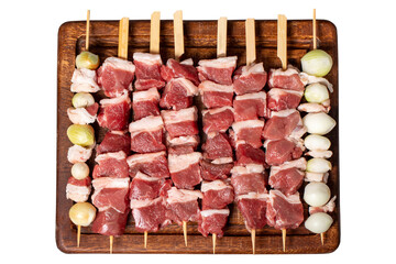 Lamb skewered meat isolated on a white background. Barbecue meat made from lamb leg on a wooden presentation board