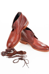 Pair of Tanned Derby Boots Made of Calf Leather with Leather Sole Placed In Line With Shoe Laces On One Another On Pure White Background.